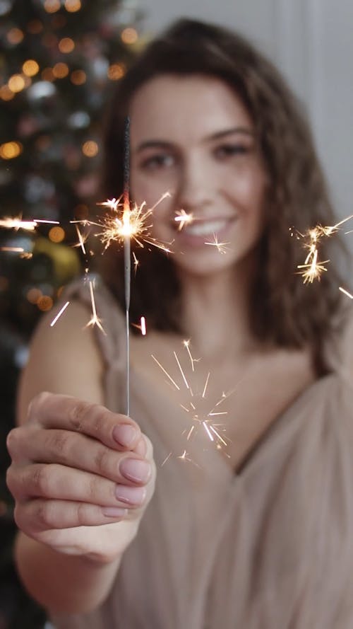Woman Holding A Lighted Sparkler