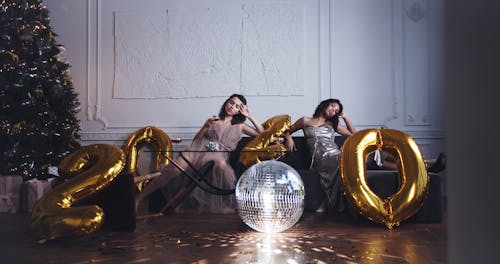 Two Women In Party Dress Poses For A Photo Shoot Welcoming The New Year
