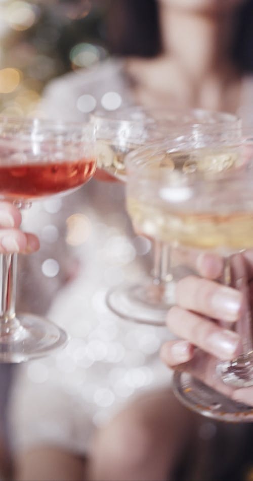 A Girl Tossing Her Glass With Friends In A Party