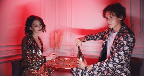 A Couple Drinking Champagne On The Corner Table Of A Disco