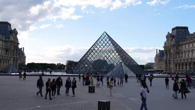 louvre pyramid courtyard on a cloudy day