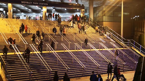 People Going Up And Down The Stairs Leading To The Wembley Park Station