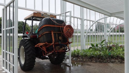 Man Using A Tractor To Water Plants