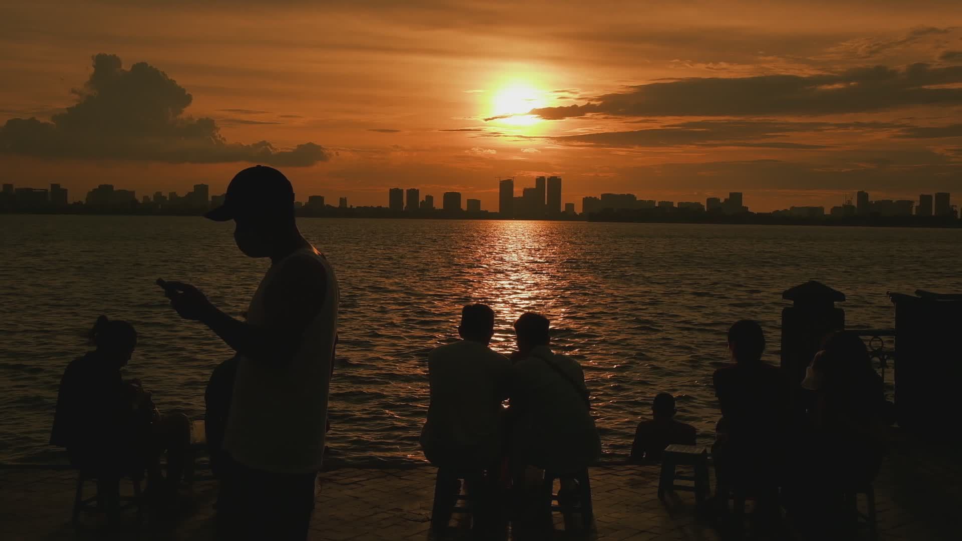 Silhouette of People Watching Sunset Over City Skyline Free Stock Video ...