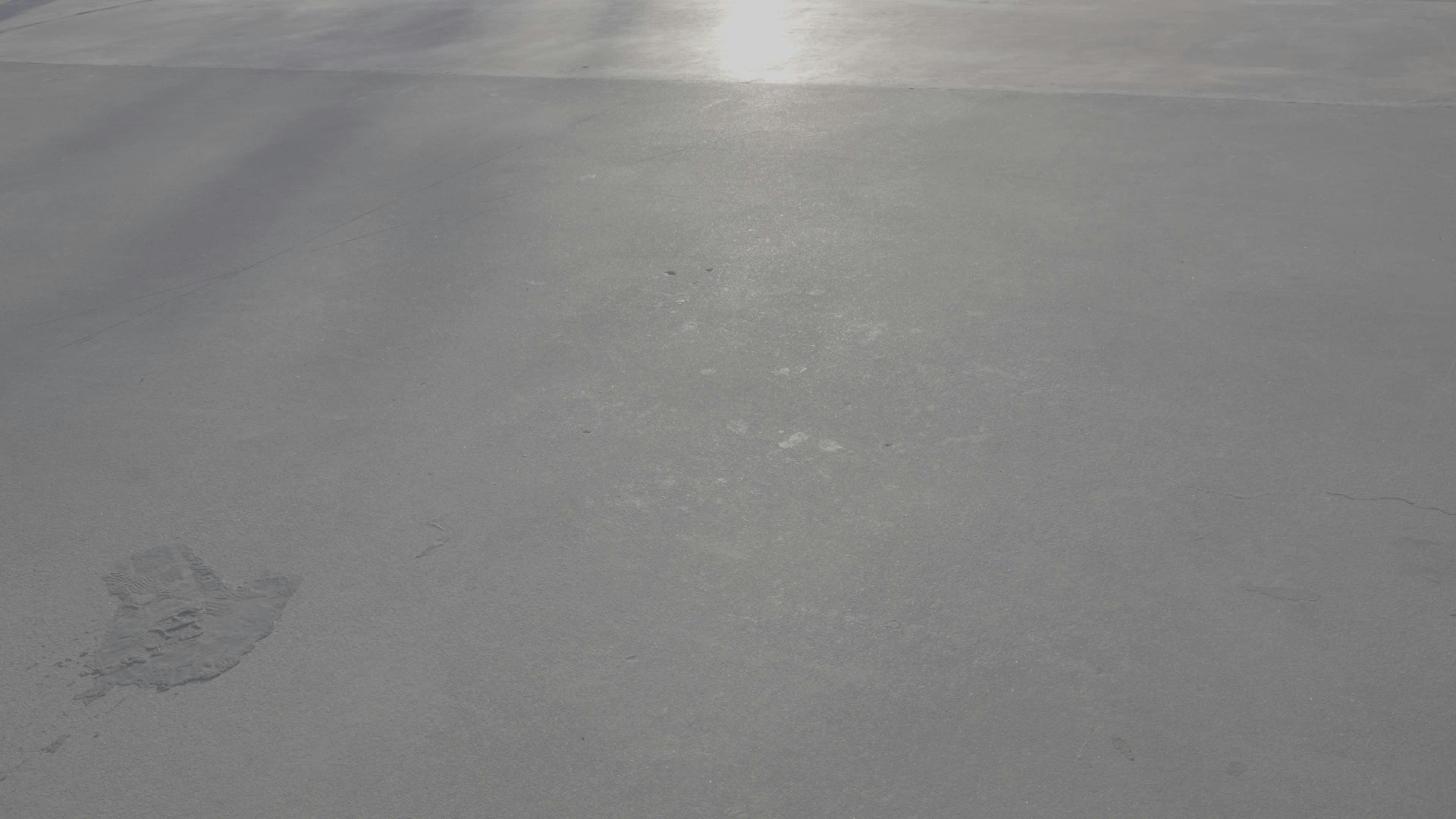 shadows of walkers on sunlit pavement 34322767