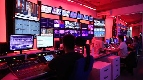 Men Working In The Control Room Of A Broadcasting Network Company