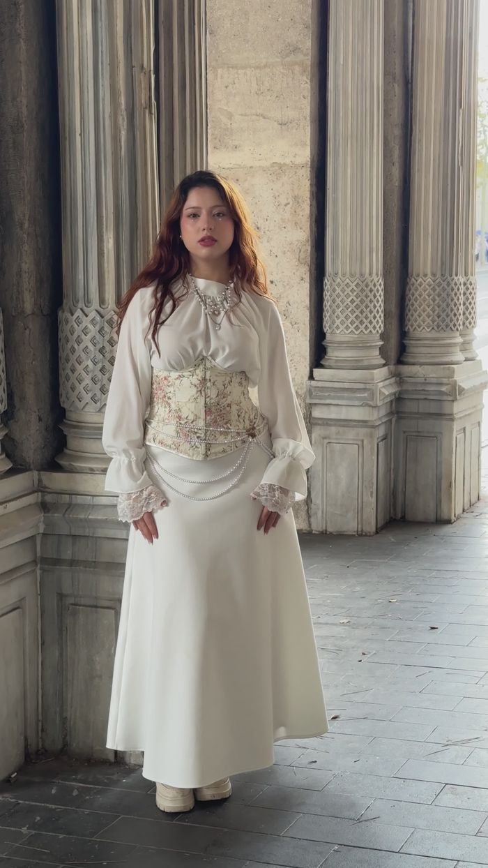 Cream blouse and white maxi skirt at classical columns
