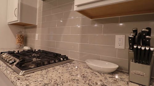 A Clean Kitchen With Gas Range On Counter Top