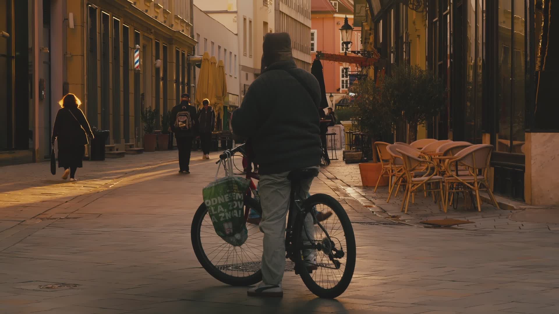 bicyclist navigates quaint european street at dusk 34597892 — free pexels stock footage