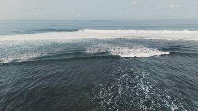 aerial view of ocean waves crashing in the sea