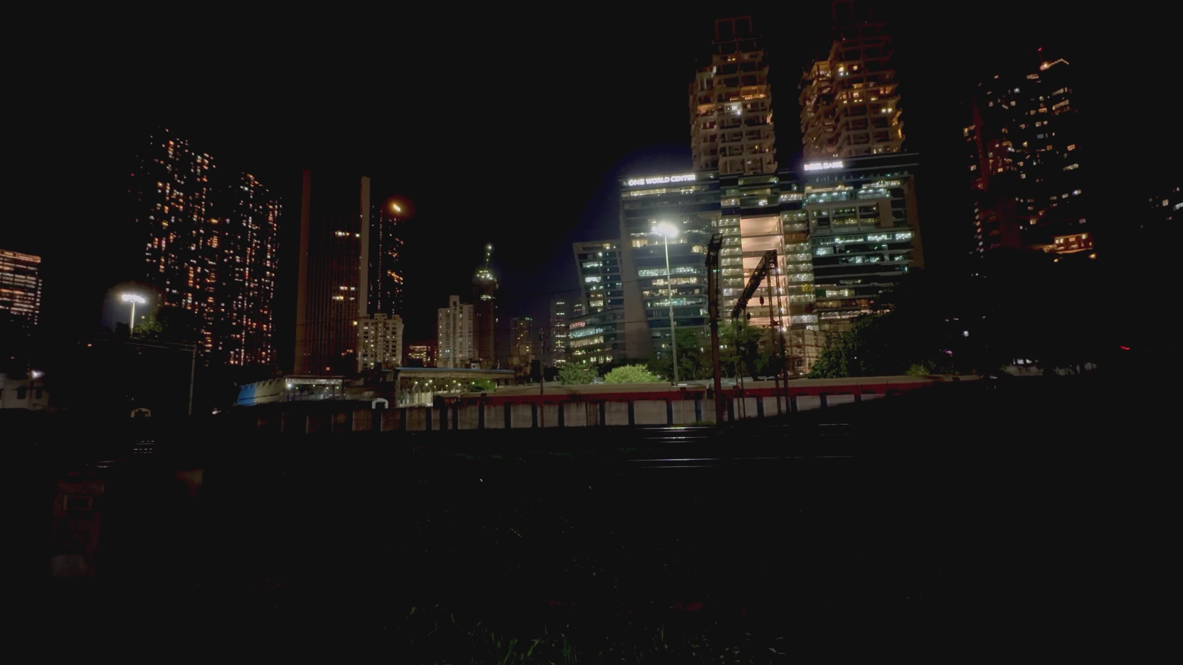 vibrant city nightscape with passing trains 34637624