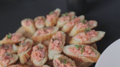 appetizing salmon canapes on wooden platter