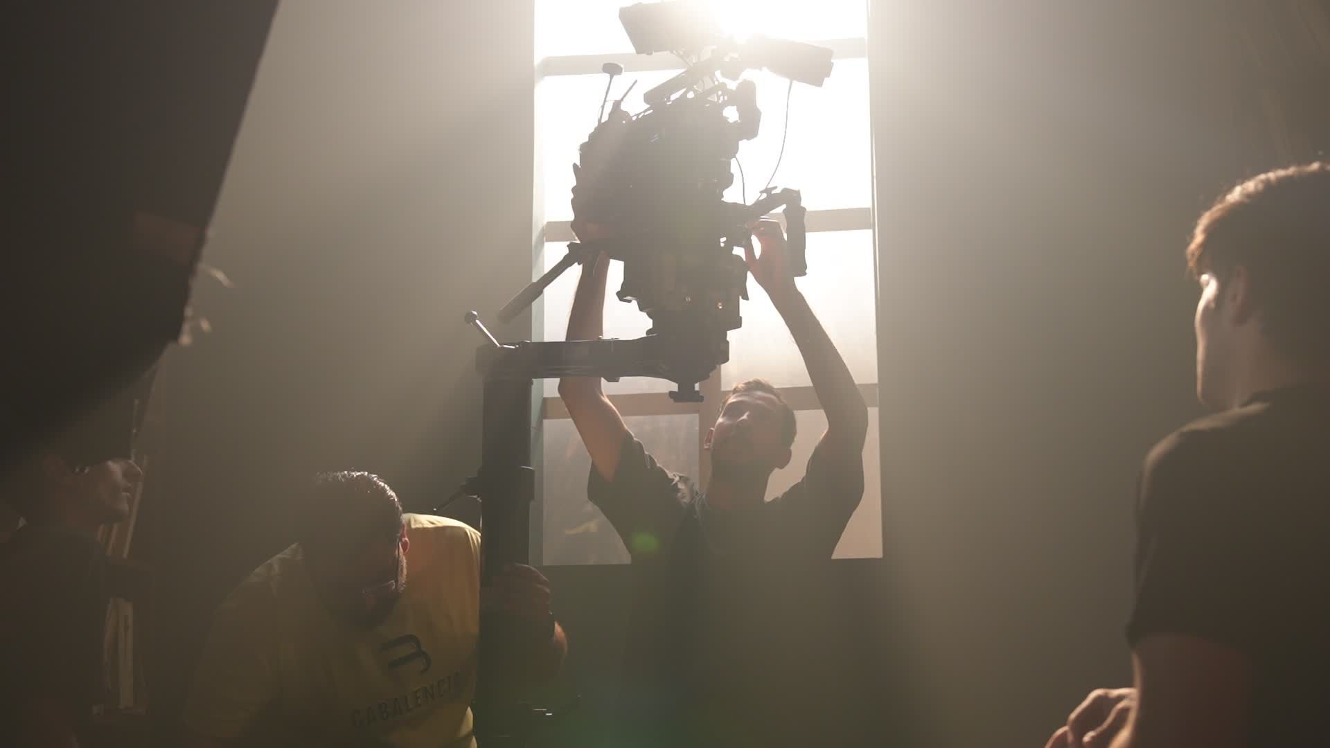 A cinema camera on set under key light