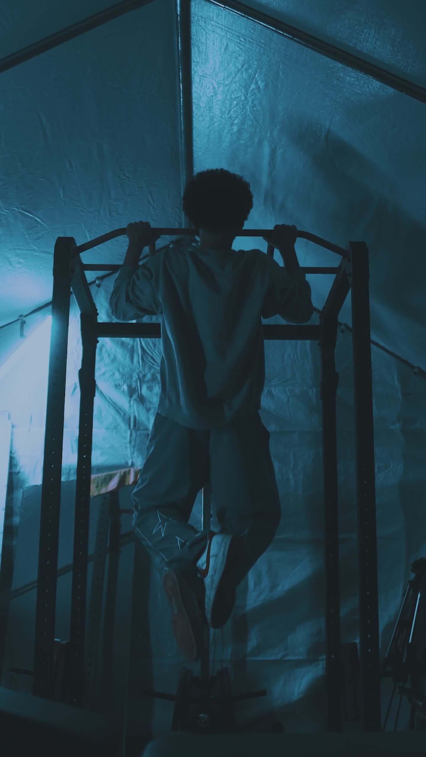 intense indoor pull up workout in blue hue 34708329