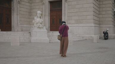 photographer captures statue in budapest street scene