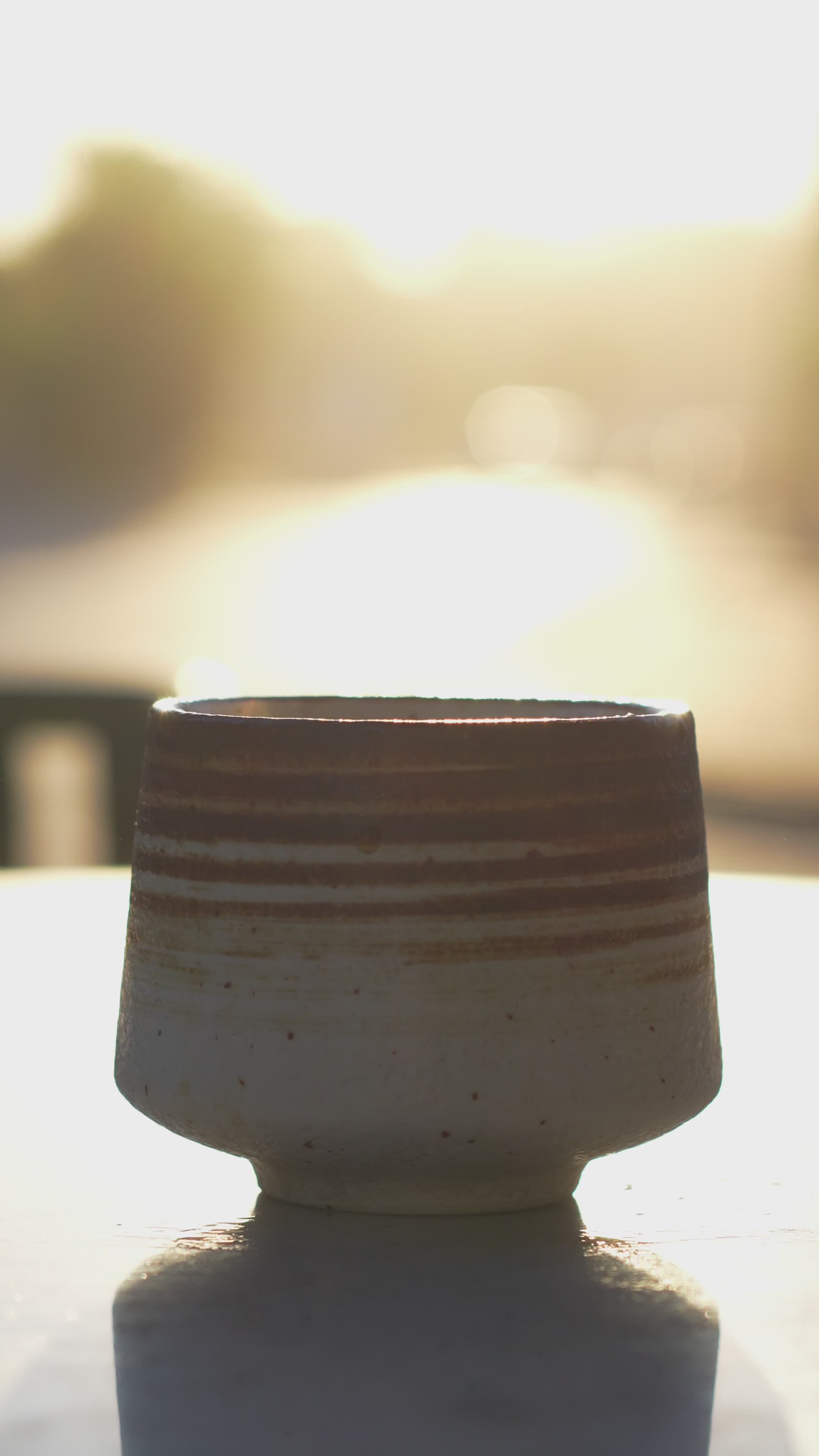 golden liquid pouring into ceramic cup at daylight 34768277 — free pexels stock footage