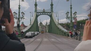 yellow tram crossing budapest s liberty bridge