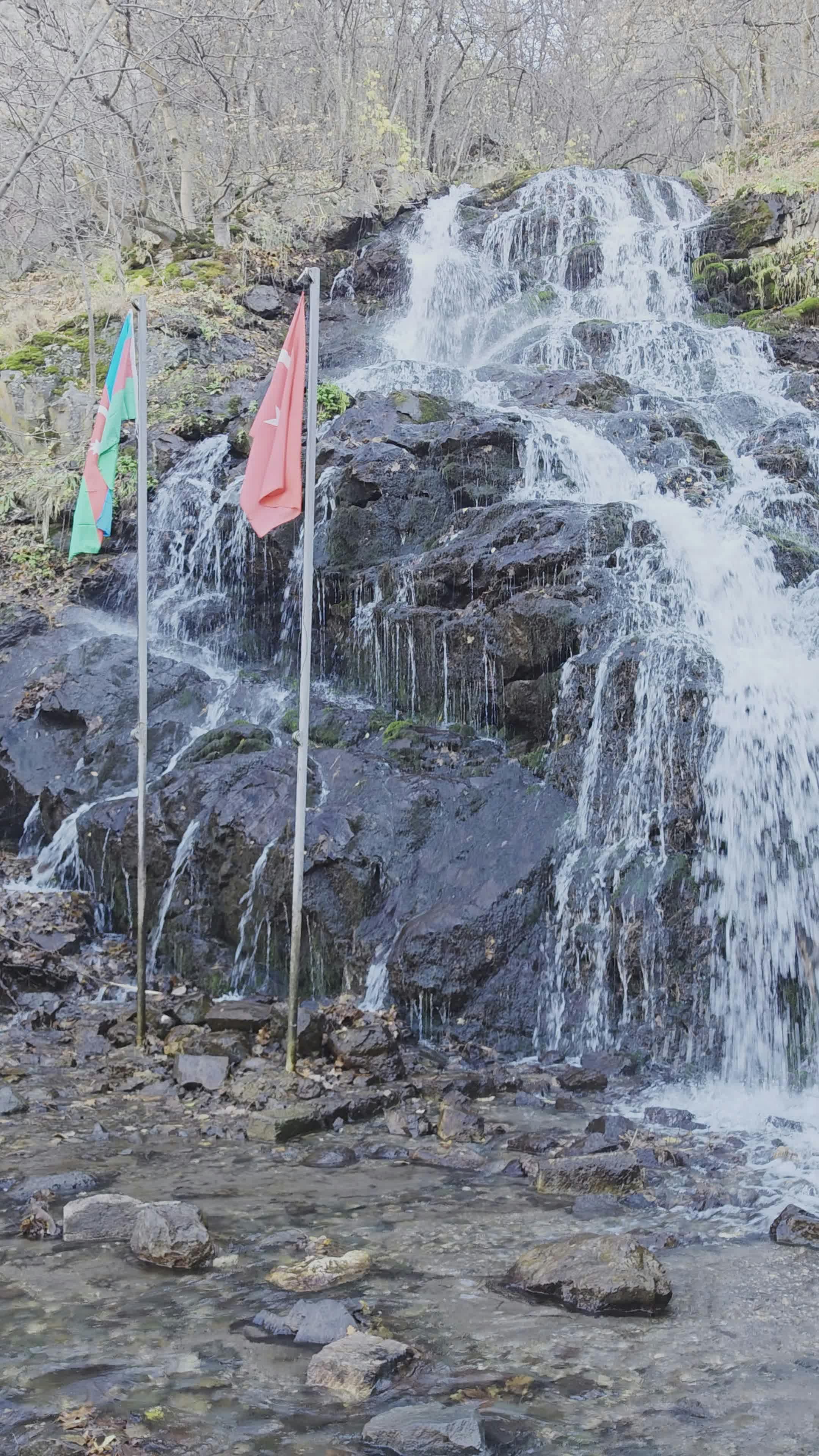 peaceful waterfall with colorful flags 34793280