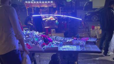 bustling night market street vendor in dhaka