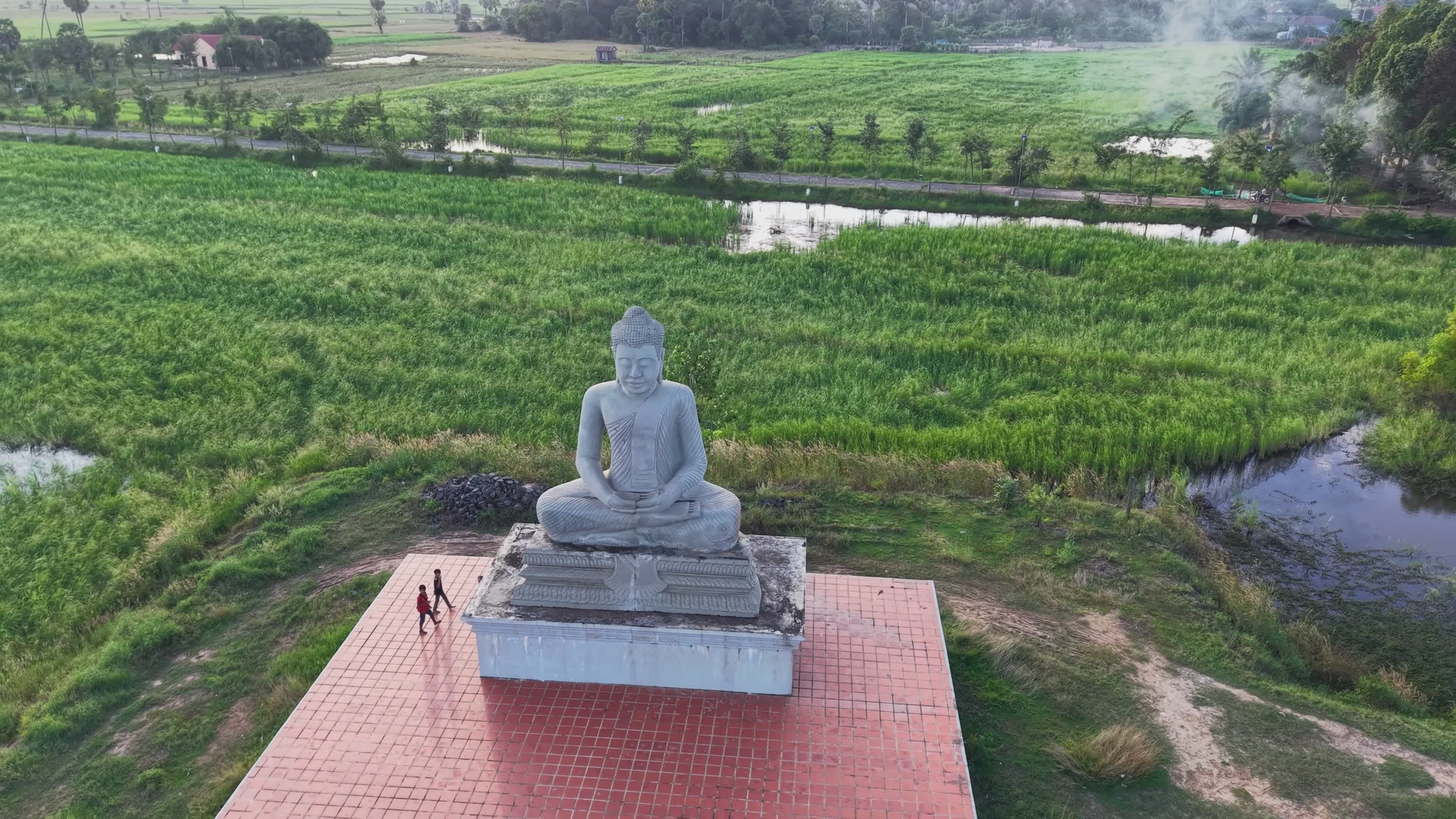 Aerial View of Buddha Statue in Lush Green Fields Free Stock Video ...