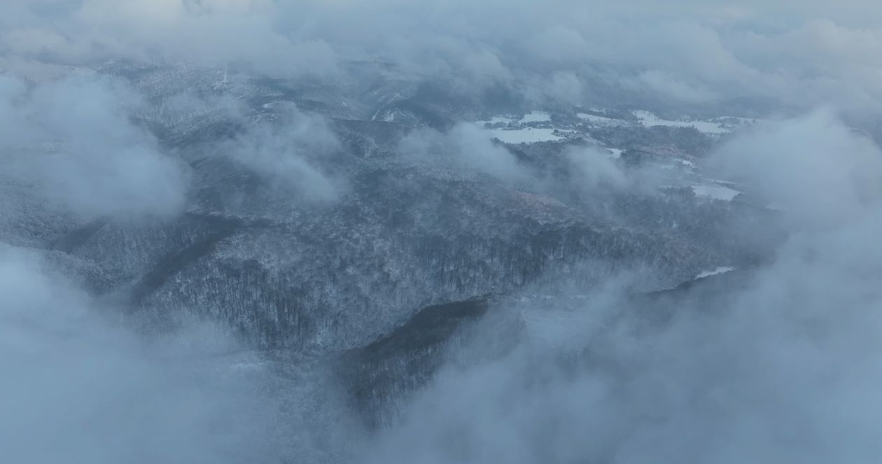 Aerial View of Snowy Mountains Through Clouds Free Stock Video Footage ...