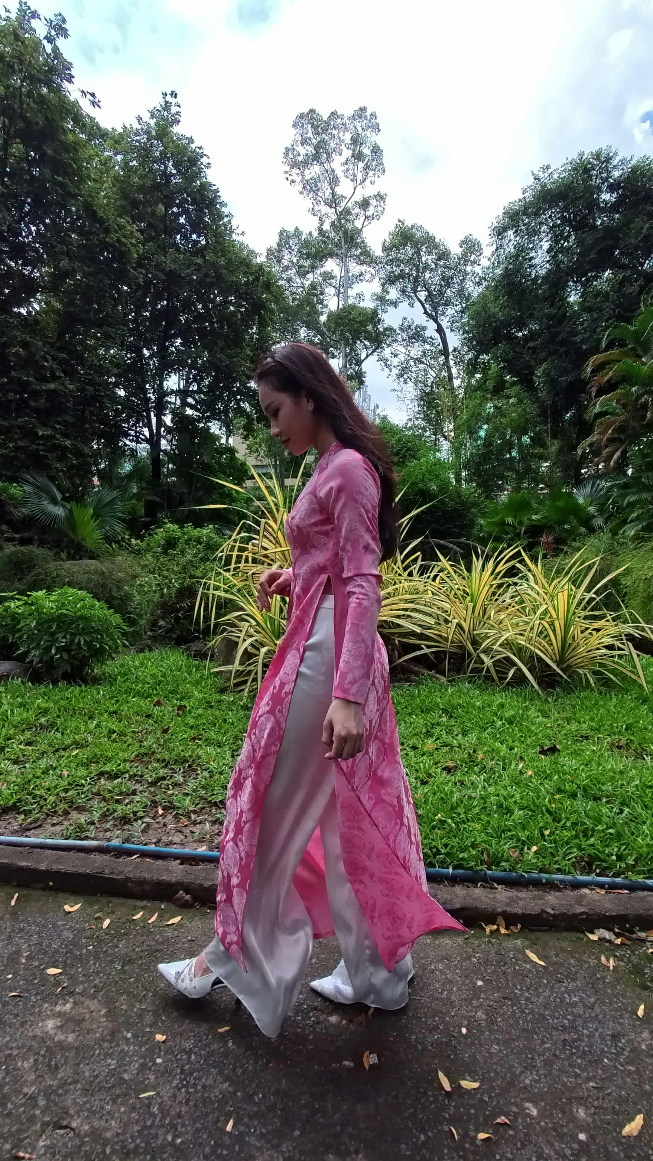 Elegant Woman Walking in Lush Garden