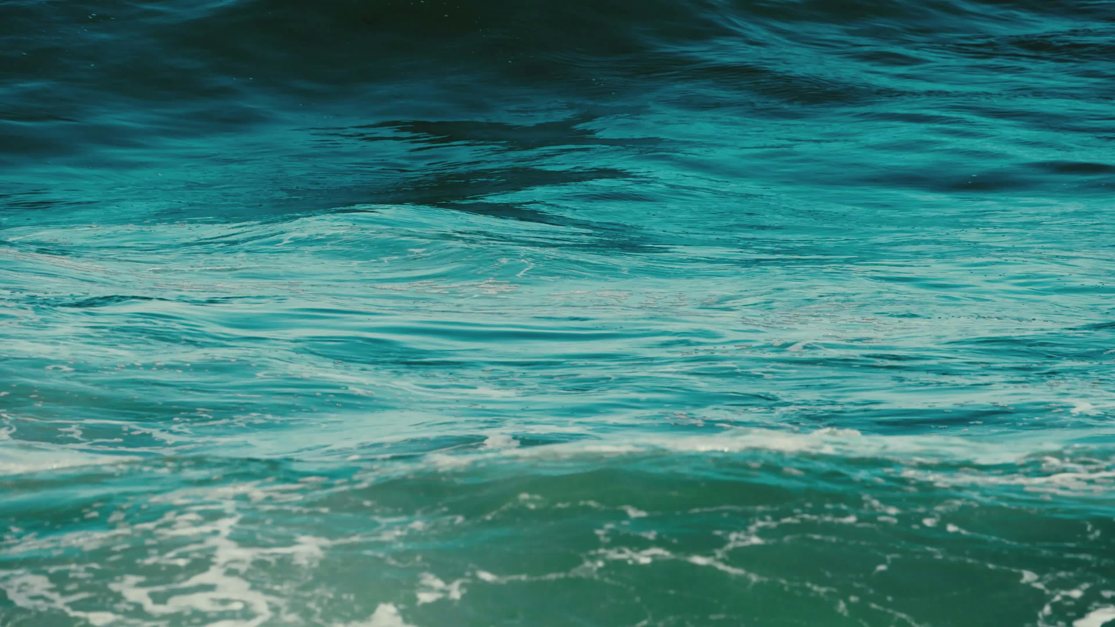 calm ocean waves in bright sunlight 34964457
