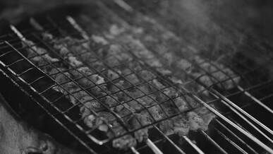 grilling meat on traditional barbecue