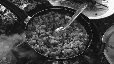 outdoor campfire cooking in a pan