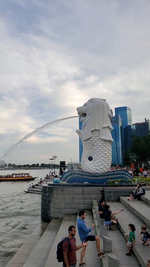 People Gathering Beside The Lion Fountain In Singapore