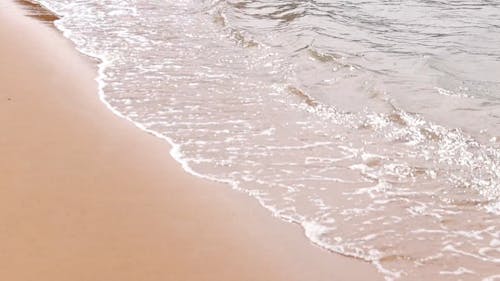 Sea Waves Kissing The Smooth Sand Of The Shore