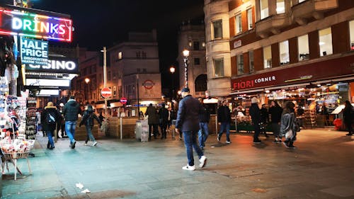 People Walking On A  Commercial Street At Night
