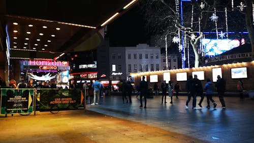 People In The Walking Street In Front Of A Casino Building In London