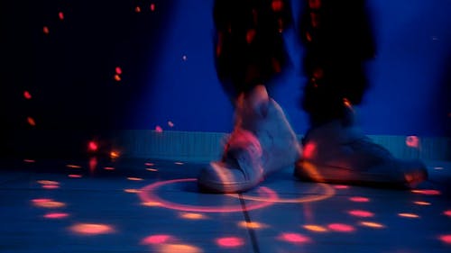 A Person Wearing White Sneakers Showing His Dancing Skill