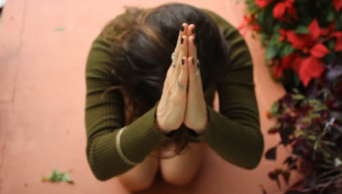 Woman Kneeling on Her Knees Praying Hard