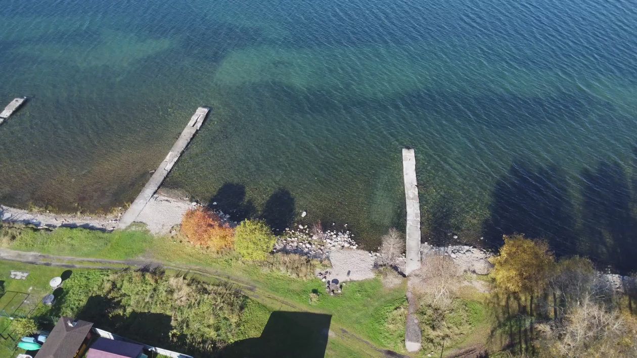 Aerial View of Serene Lake with Wooden Docks Free Stock Video Footage ...
