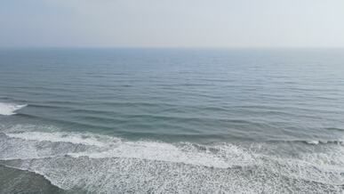 aerial view of serene ocean waves at sunrise