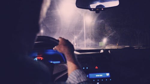 Man Driving A Car At Night