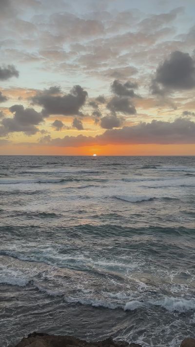 Women Manifest Success's ocean waves sunset video