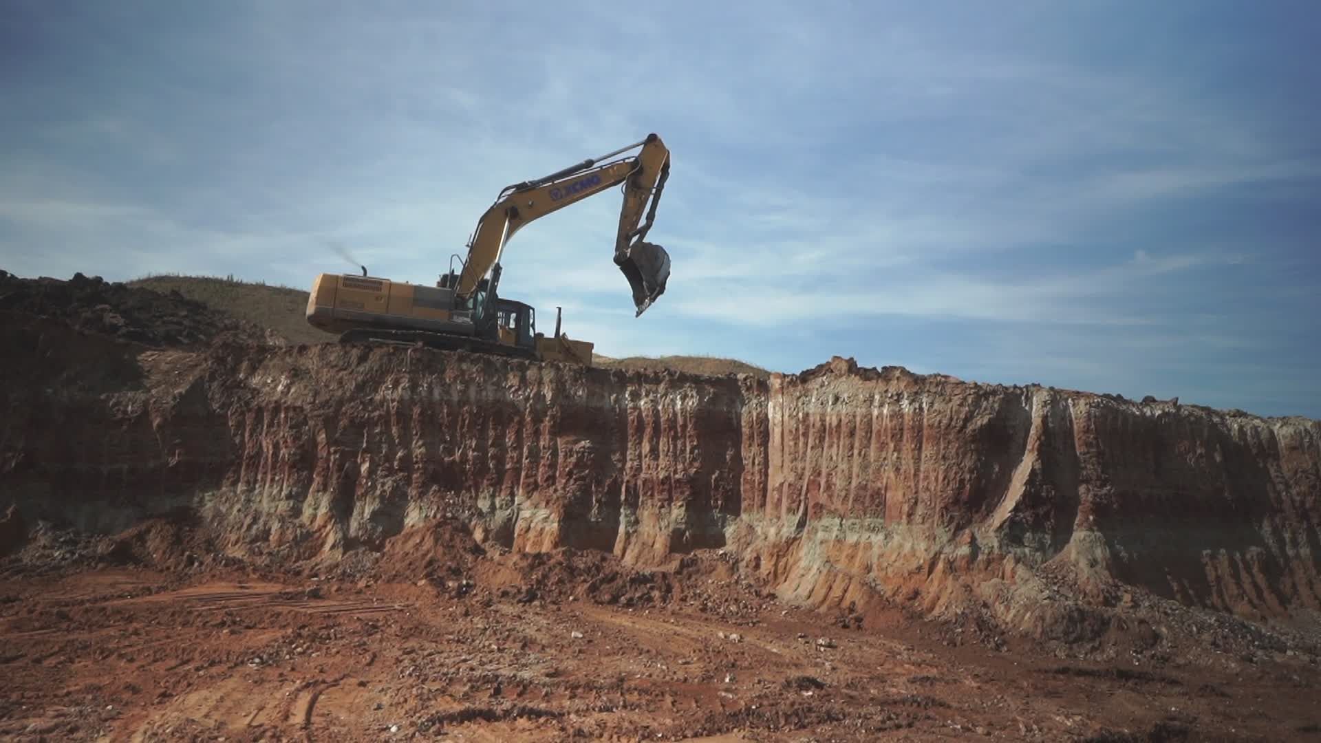 Digging In Rocks Heavy Excavator Digging in a Rock Quarry Free Stock Video Footage ...