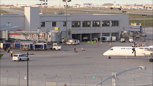 A Turboprop Airplane Docking On The Terminal Area