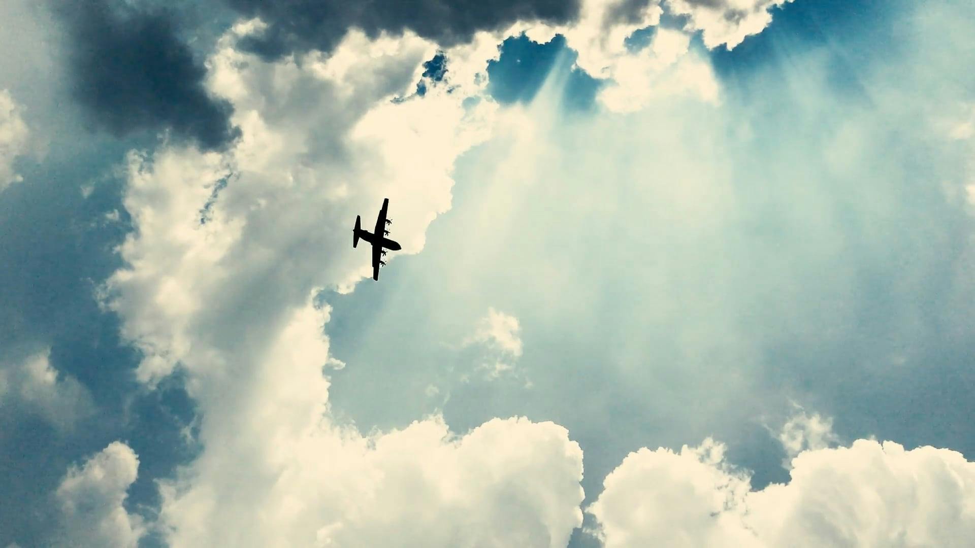 An Airplane Flying Beneath The Thick Clouds Formation In The Air · Free ...