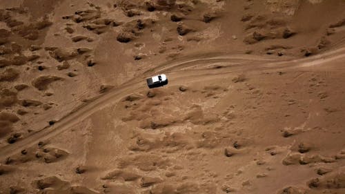 Vehicle Traveling In The Middle Of The Desert