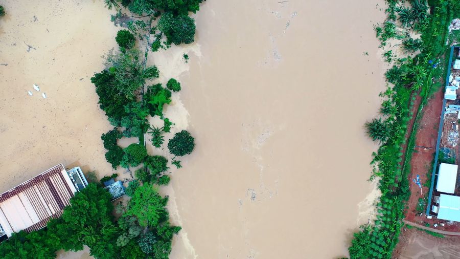 Aerial view of flooding along a river, representative of coastal flood risk monitoring.
