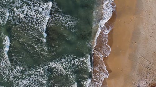 Aerial Footage Of Sea Waves Kissing The Shore