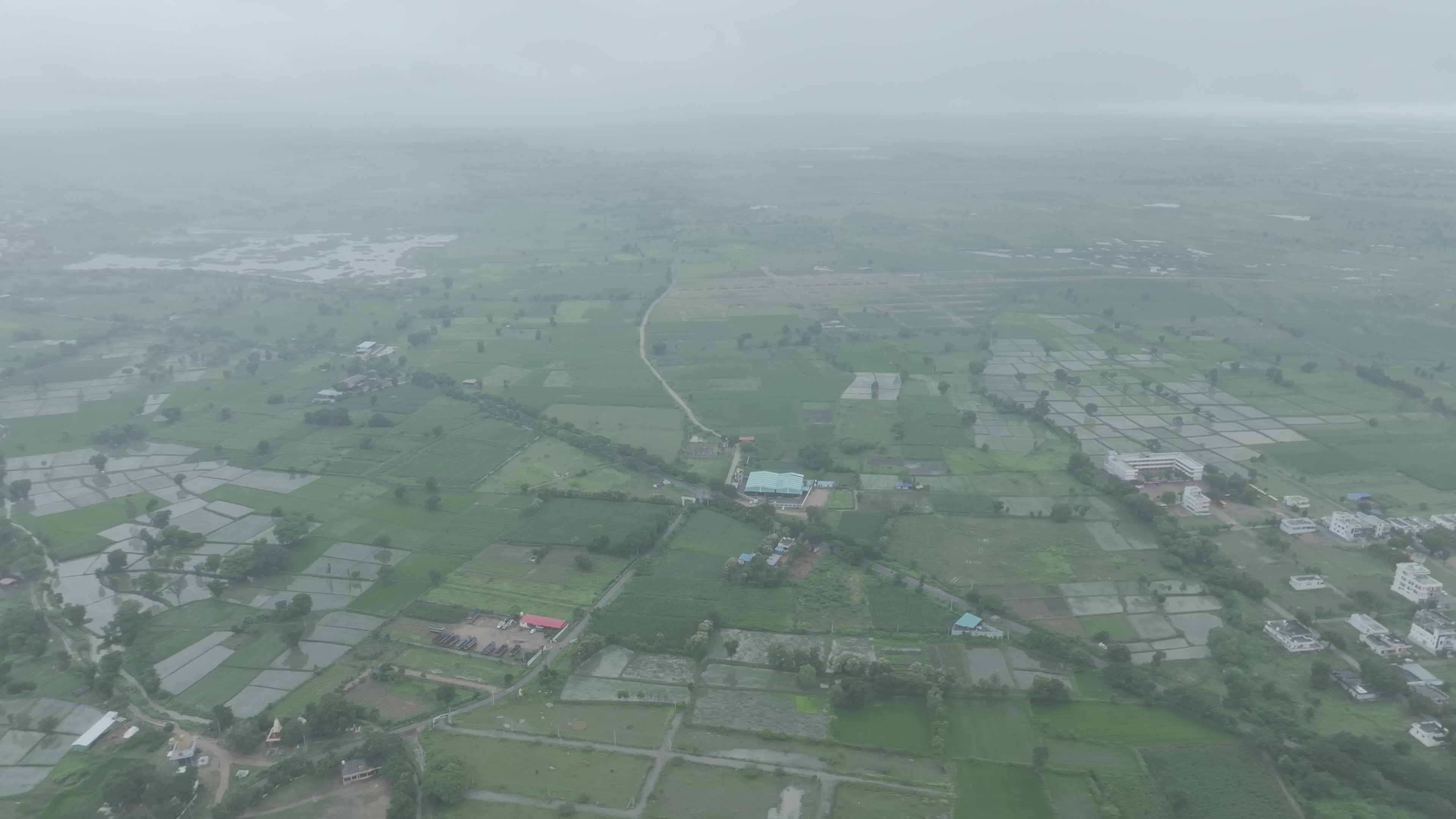 Aerial View of Lush Green Fields on a Cloudy Day Free Stock Video ...