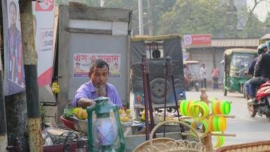 street vendor selling fruit in busy urban market