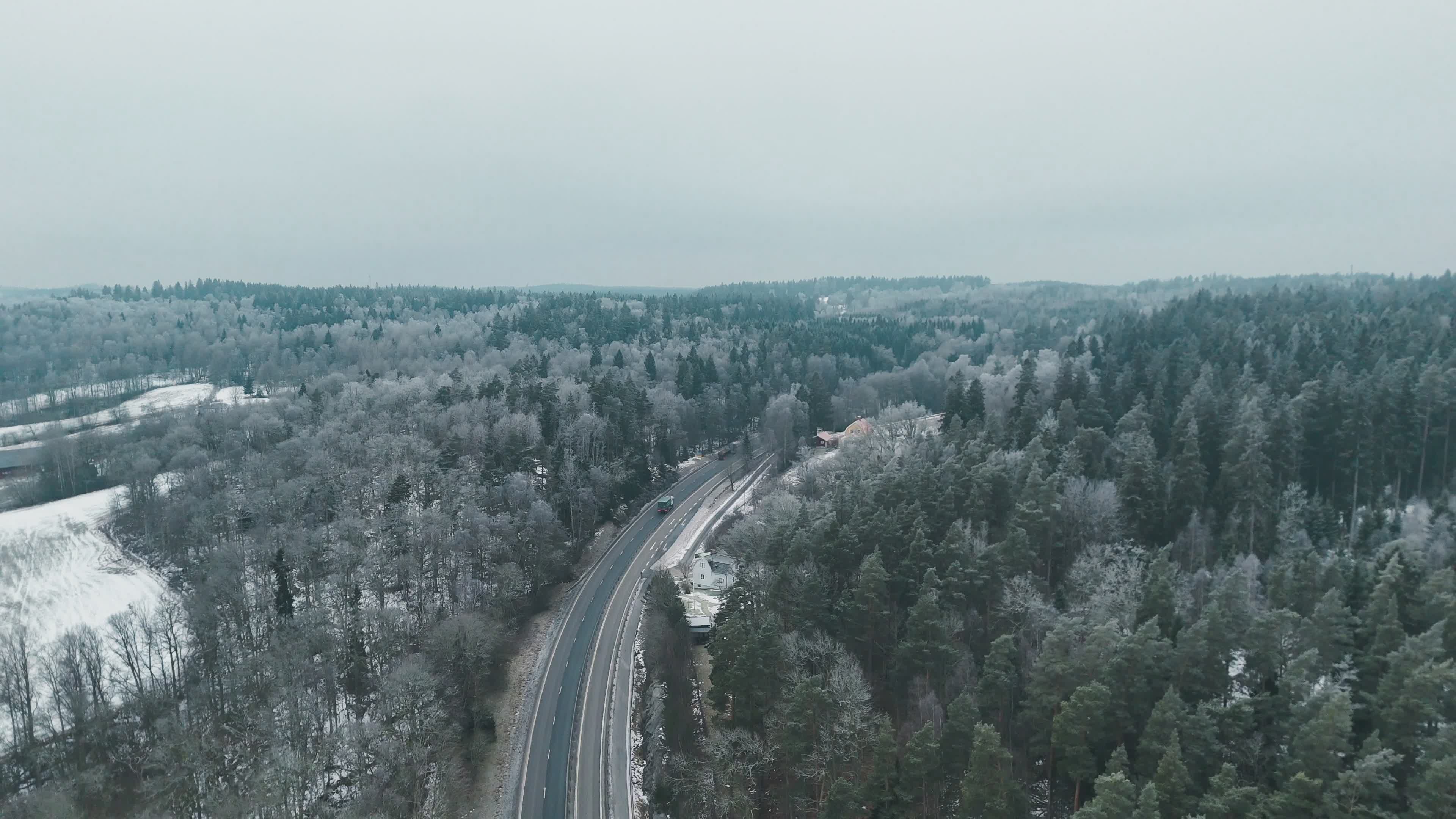 Aerial View of Snowy Forest Road in Winter Free Stock Video Footage ...