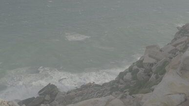 waves crashing against rocky shoreline