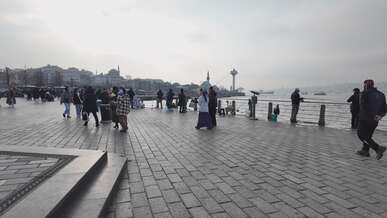 crowded waterfront promenade during daytime